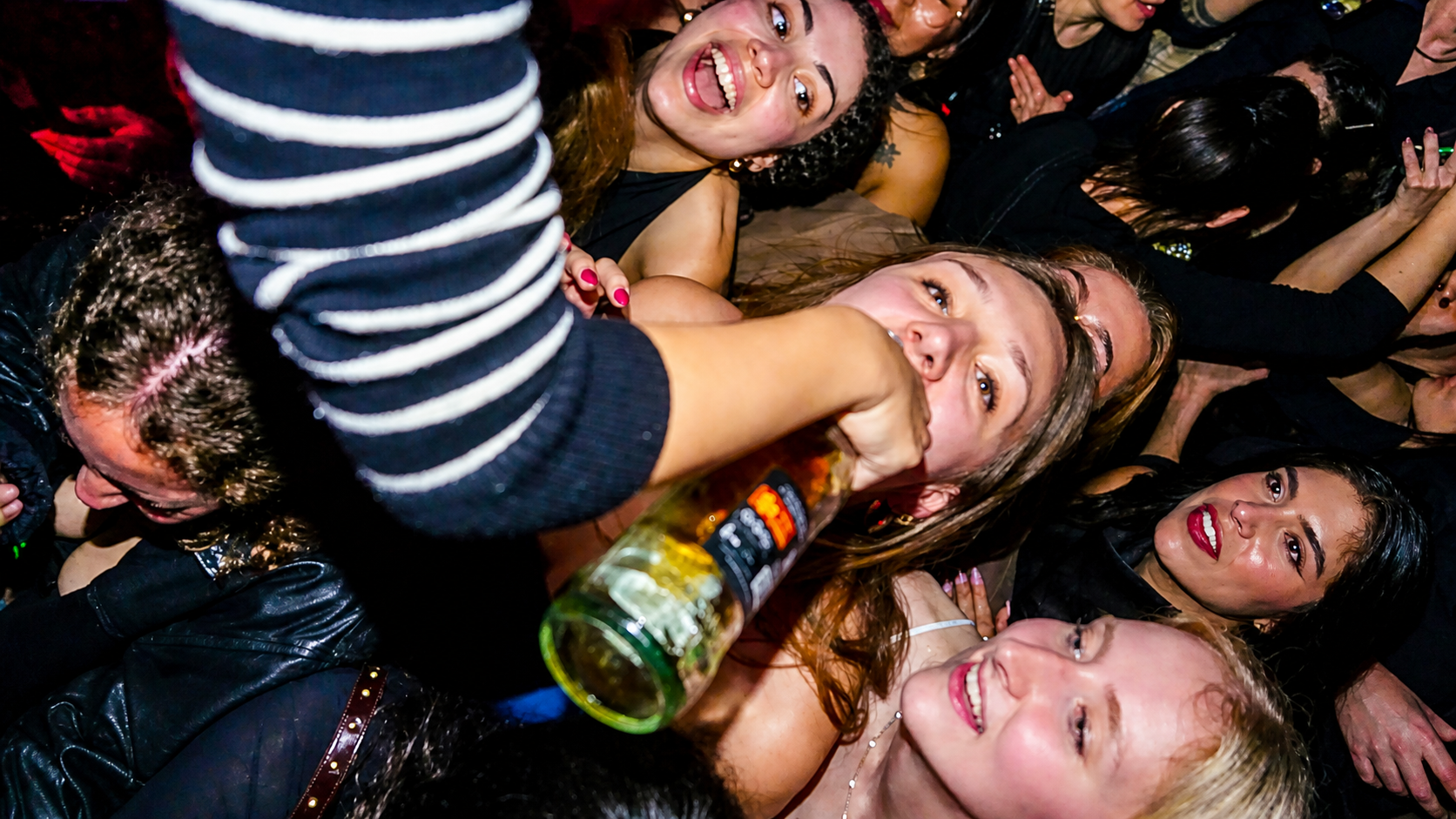 Party crowd in a Paris nightclub during a lively Pub Crawl Paris stop