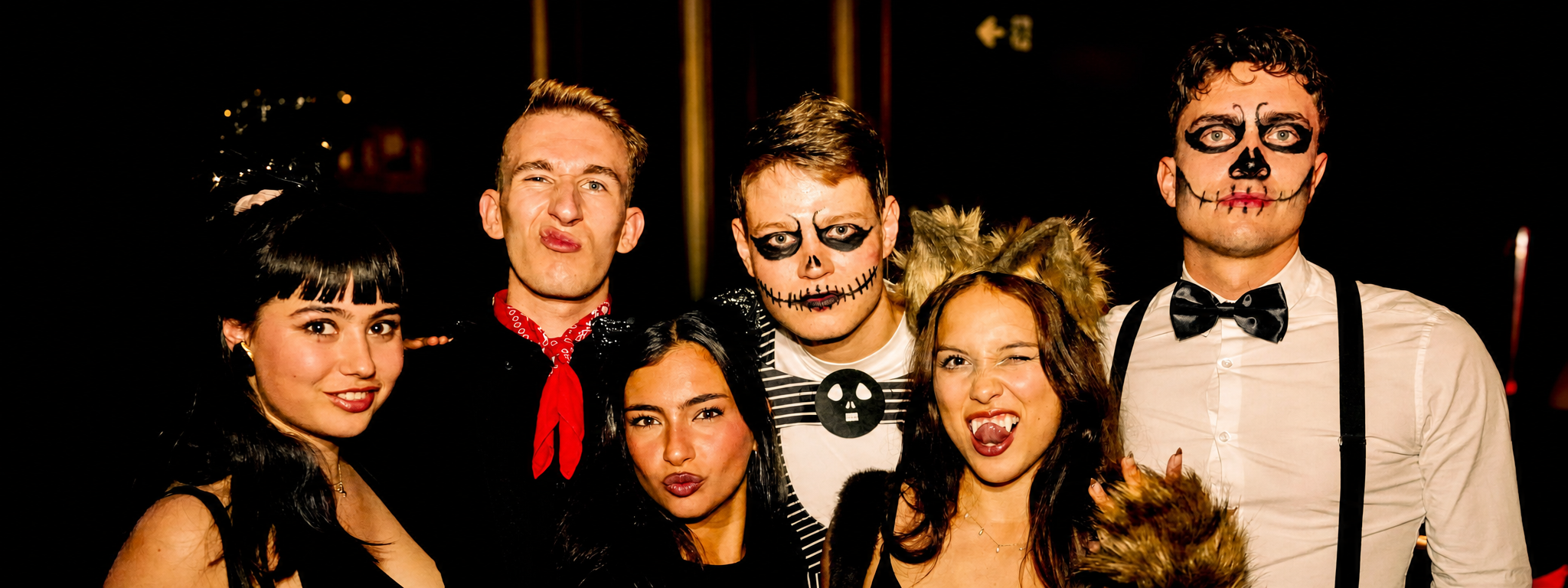 Halloween costumes and skeleton makeup at a Pub Crawl Paris party night