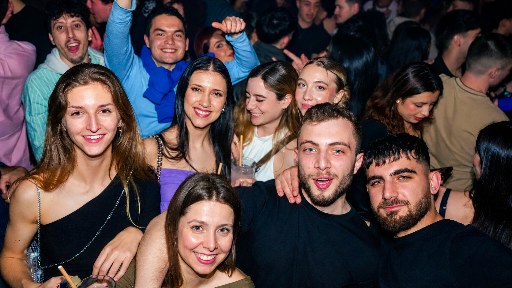 Group of travelers enjoying a Pub Crawl Paris nightlife experience in a club