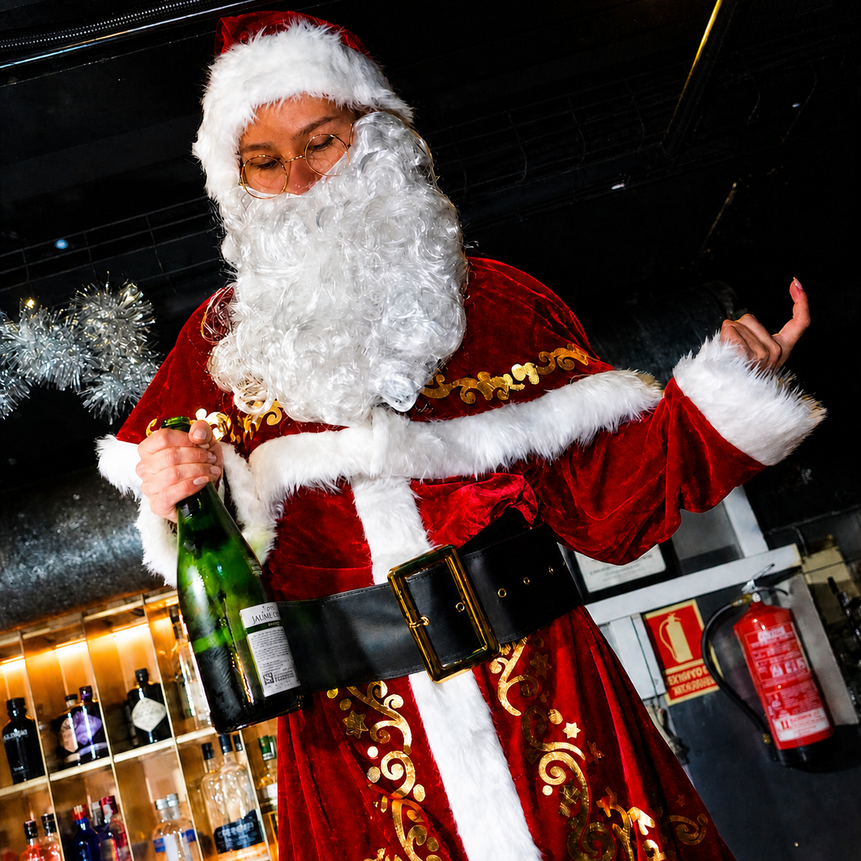 Santa holding a bottle during a festive Pub Crawl Paris Christmas party